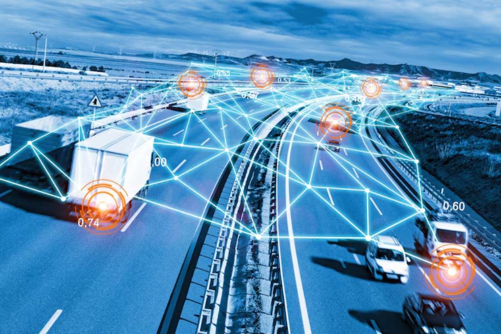 A busy highway with trucks and cars, overlaid with a digital network and location markers displaying data points.