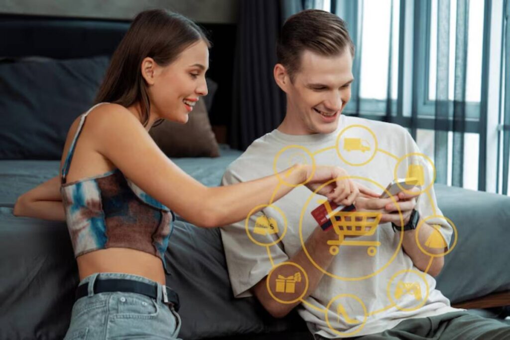 A woman and a man interact while shopping online, with digital shopping icons overlaid on a cozy bedroom backdrop.
